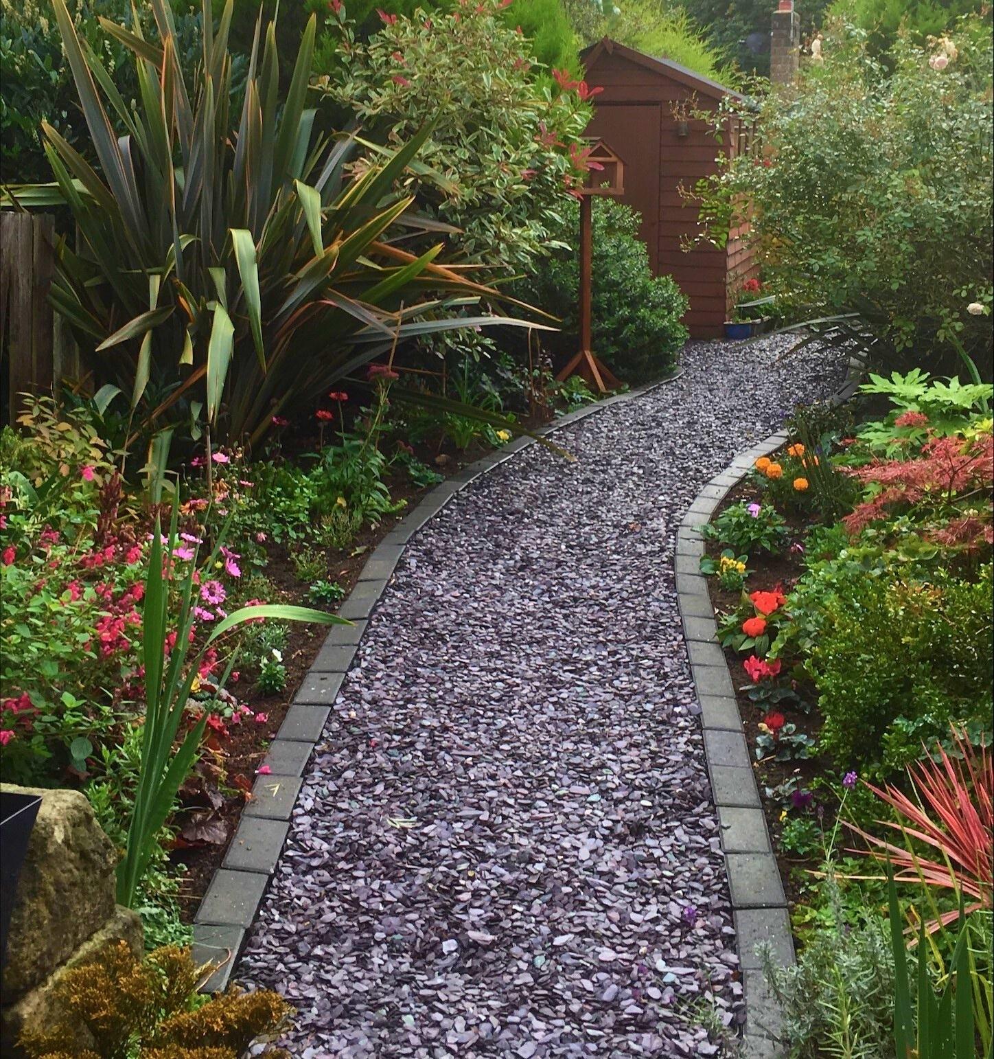 Garden featuring blue slate chippings as a path