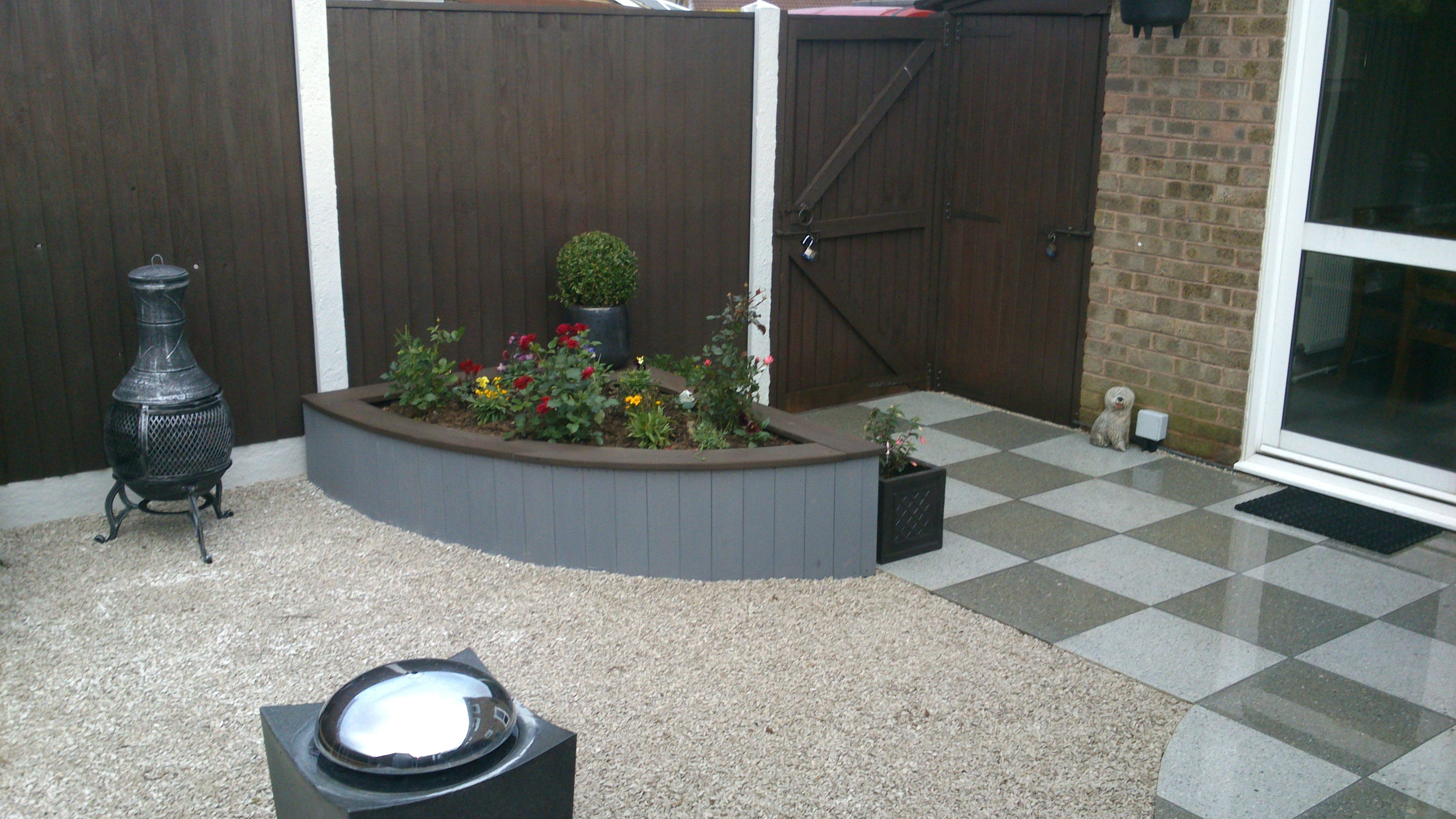 A garden with a patio and gravel