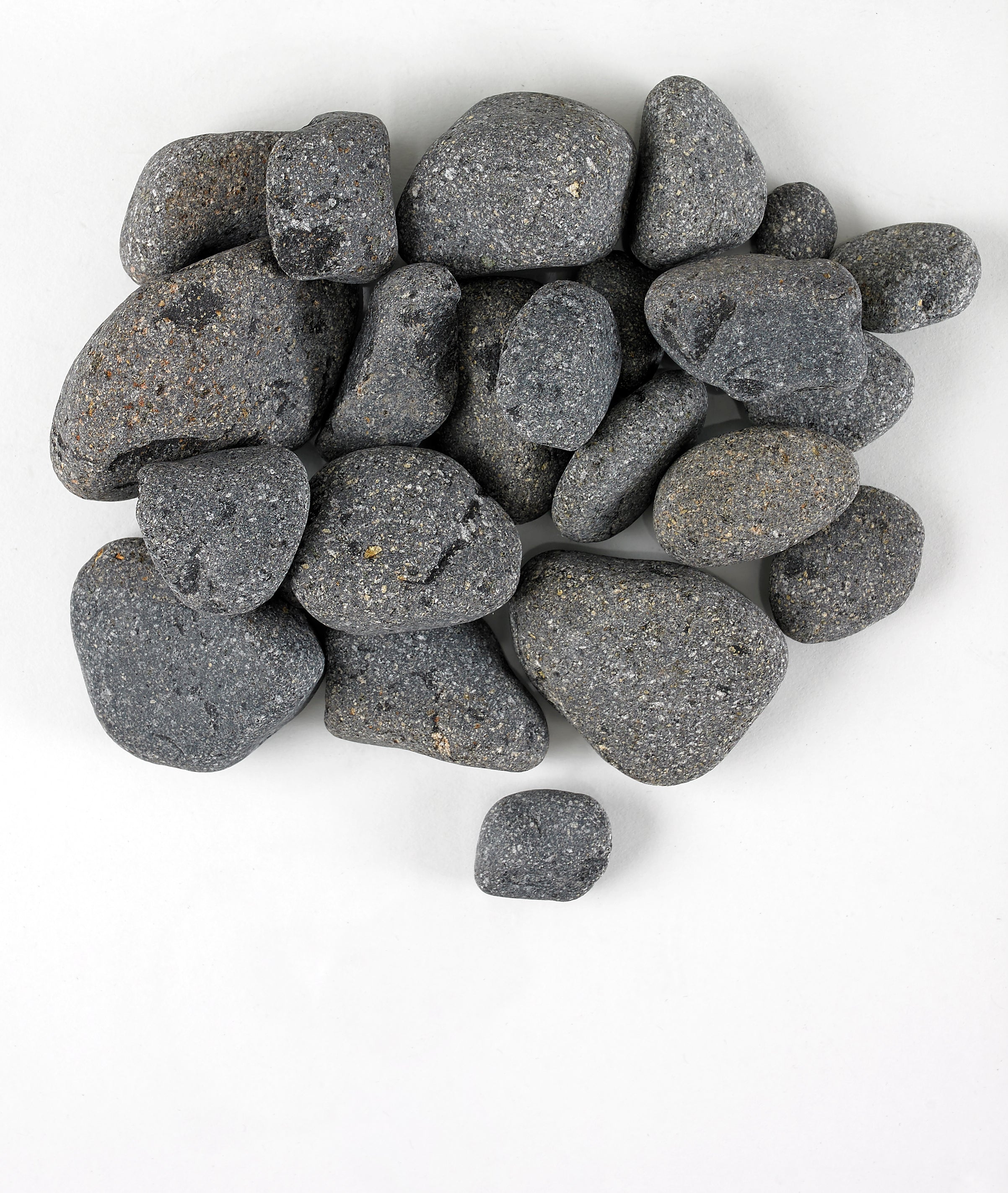 A collection of tumbled black pebbles of various sizes arranged on a white background.