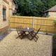Gold gravel garden with table and chairs