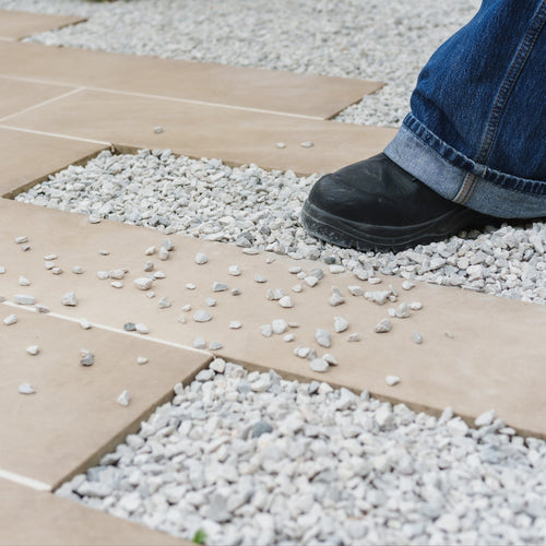 Pathway with loose gravel before Gravel Grip application