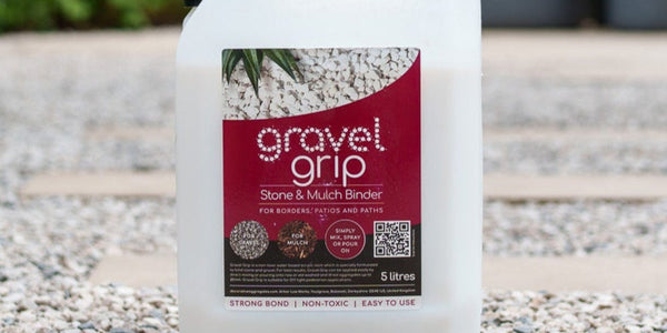 Container of Gravel Grip on a gravel surface with plants in the background