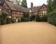Large resin bound driveway that is golden in colour 