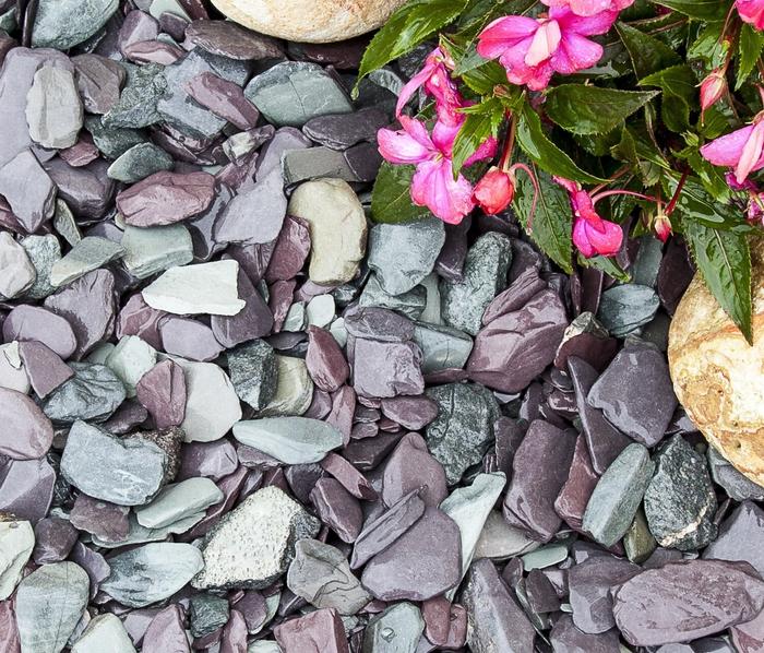 snowdonia tumbled slate next to pink flowers and rockery