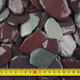 close up product image of snowdonia tumbled slate with tape measure for size reference