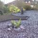 Close of plum slate arranged in circles with plants and rockery