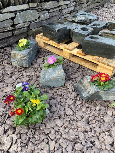 slate planters with flowers placed in side 