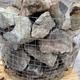 wire basket full of welsh quartz granite boulders