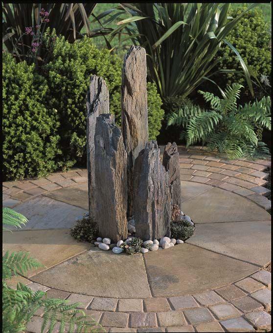 multiple slate monoliths together in a garden 