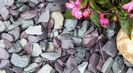 Slate Chippings laid next to pink flowers