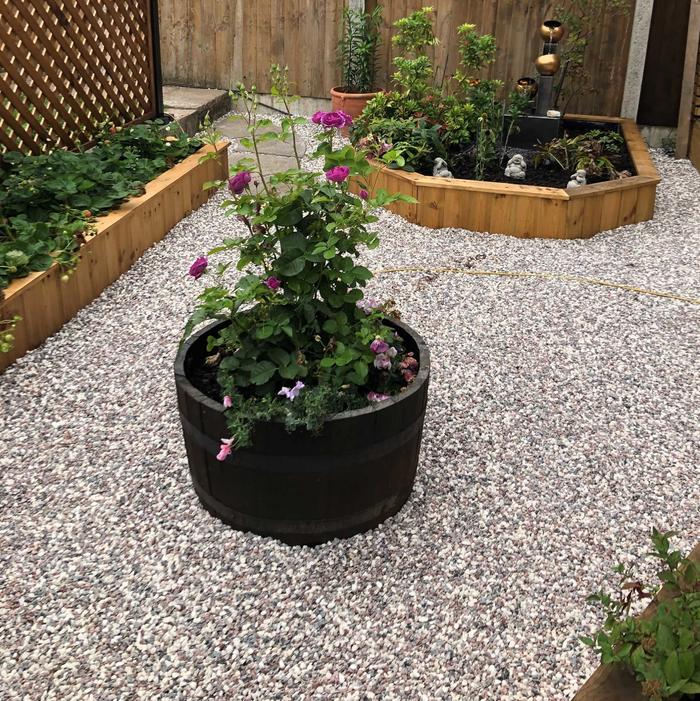 Red and white garden gravel near planting beds