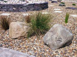 large welsh granite boulders laid on planting area near slate walling 