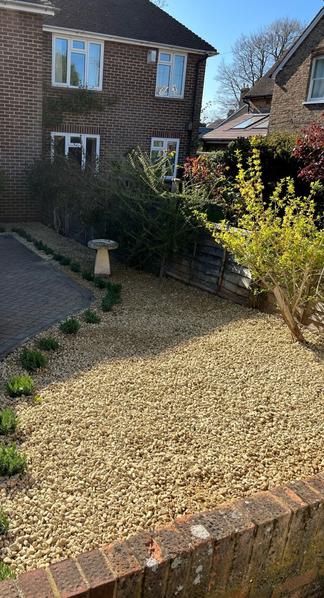 All gravel front garden using natural cream aggregates, laid around shrubs and trees