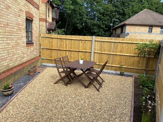 gravel patio with dining furniture