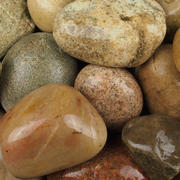Close up image of scottish cobbles 50-80mm featuring a mixture of natural colours 