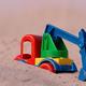 Toy digger in play pit sand 