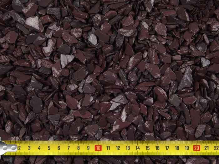 Close up image of plum and blue slate mini mulch with tape measure to showcase size