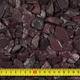 Close up of plum slate chippings with tape measure for scale