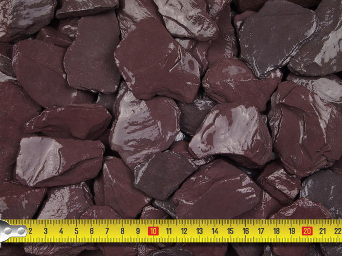 Close up of plum slate chips with a tape measure guide