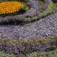 Plum slate chips in a circular flower bed