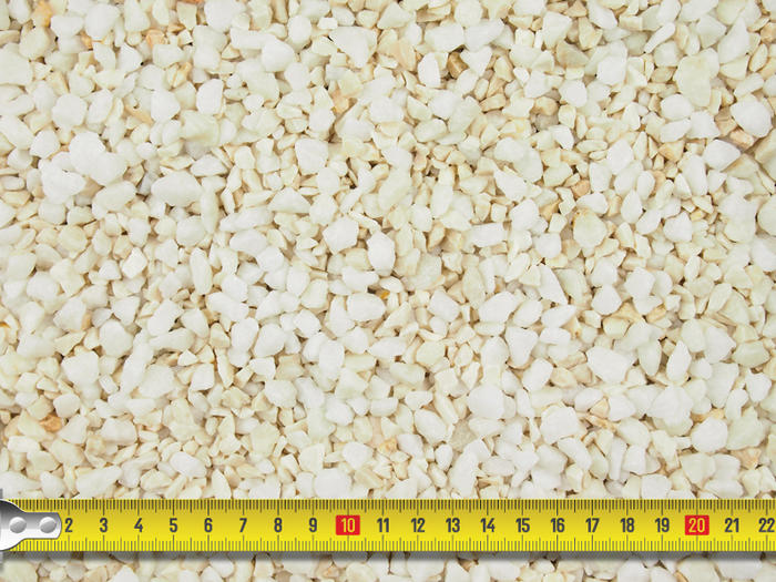image showcasing the size of white and cream, Ashton Cream pebbledashing aggregates with tape measure