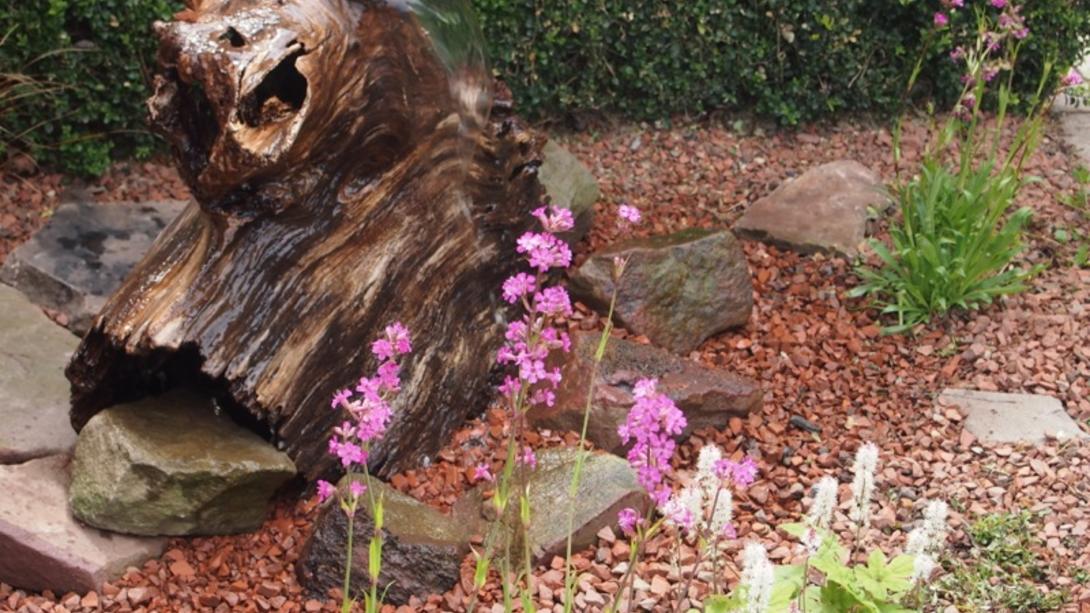 dark pink gravel laid around flowers and plants 